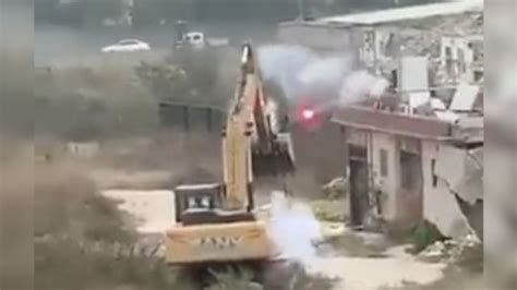 chinese man fights off excavator with fireworks|Man in China uses fireworks to fight off bulldozer sent to  .